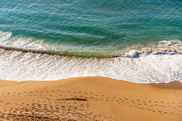 Beautiful tropical white empty beach and sea waves seen from above.