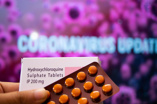 Hydroxychloroquine Sulphate tablets with coronavirus written in background