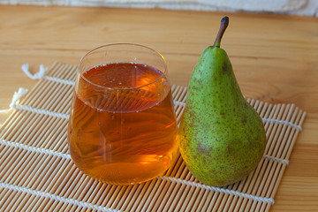 Delicious fresh squeezed pear juice in  transparent glass