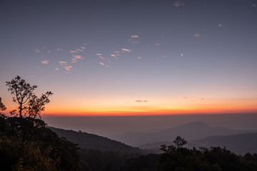 Twilight, sunrise and sea of fog in the morning on the mountains of northern Thailand, during the rainy season.