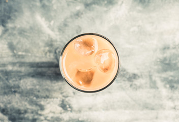 Iced coffee with cream on the rustic background. Selective focus. Shallow depth of field.
