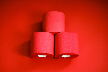 Several rolls of toilet paper isolated on lush purple background. A supply of toilet paper in case of a pandemic. COVID-19 coronavirus outbreak concept. Shortage due to buying panic. Сopy space.