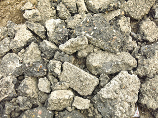 broken gray chunks of asphalt in a pile