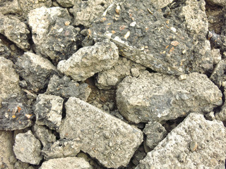 broken gray chunks of asphalt in a pile
