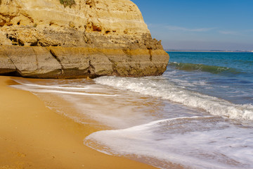 beach and cliff on Atlantic ocean in Algarve Portugal. 