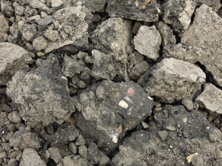 broken gray chunks of asphalt in a pile