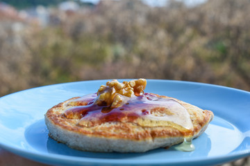 Pancakes with maple syrup, walnuts and red fruit jam.