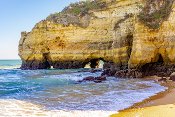 Rocks and  waves on the shore of ocean in Algarve Portugal.
