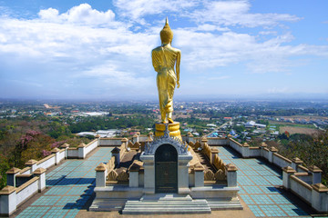The golden buddha statue and the viewpoint of Nan city , Thailand