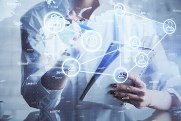 Social network theme hologram over woman's hands writing background. Concept of international people connect. Double exposure