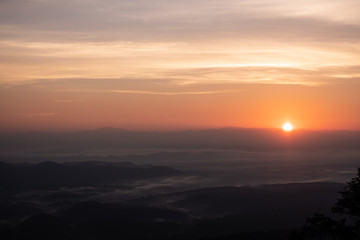 Twilight, sunrise and sea of fog in the morning on the mountains of northern Thailand, during the rainy season.
