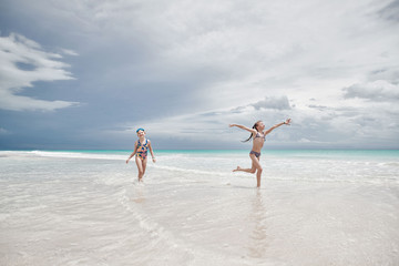 children have fun playing on the beach