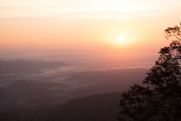 Twilight, sunrise and sea of fog in the morning on the mountains of northern Thailand, during the rainy season.
