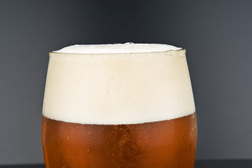 Foggy glass with cold beer on a black background