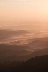Twilight, sunrise and sea of fog in the morning on the mountains of northern Thailand, during the rainy season.