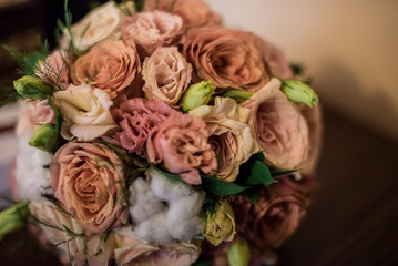 Bridal bouquet in a classic style: roses, eustoma, cotton
