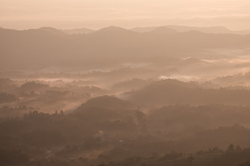 Twilight, sunrise and sea of fog in the morning on the mountains of northern Thailand, during the rainy season.