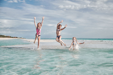 children have fun playing on the beach