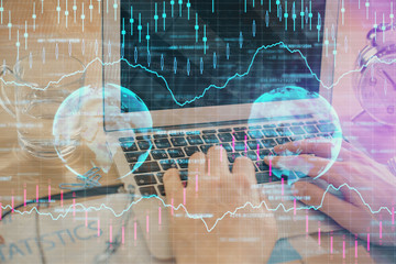 Multi exposure of market chart with man working on computer on background. Concept of financial...