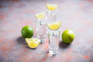 Tequila shots on the dark rustic background. Selective focus. Shallow depth of field.