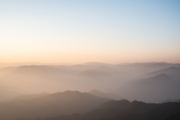 Twilight, sunrise and sea of fog in the morning on the mountains of northern Thailand, during the rainy season.