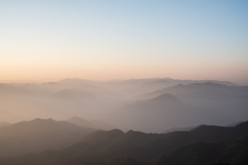 Twilight, sunrise and sea of fog in the morning on the mountains of northern Thailand, during the rainy season.