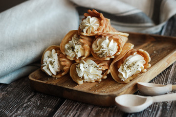Russian waffles with cream cheese and spices. Wafer rolls on the table. Delicious waffles