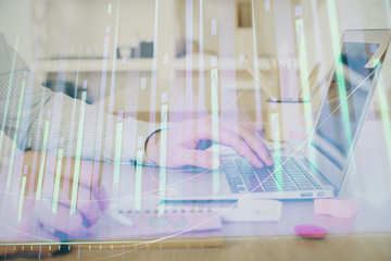 Multi exposure of stock market graph with man working on laptop on background. Concept of financial analysis.