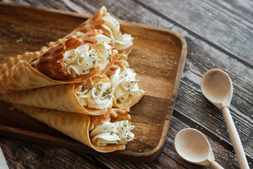 Russian waffles with cream cheese and spices. Wafer rolls on the table. Delicious waffles
