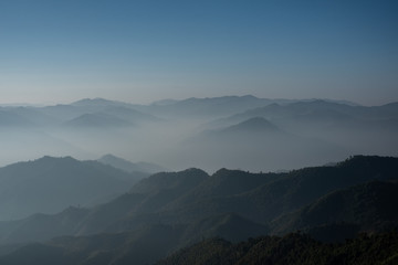 Twilight, sunrise and sea of fog in the morning on the mountains of northern Thailand, during the rainy season.