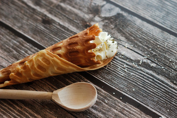 Russian waffle with cream cheese and spices. Wafer roll on the table. Delicious waffle