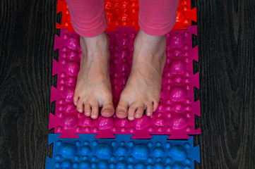 barefoot girl walks on sensory mats in the sensory integration room