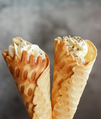 Russian waffles with cream cheese and spices. Wafer rolls on the table. Delicious waffles