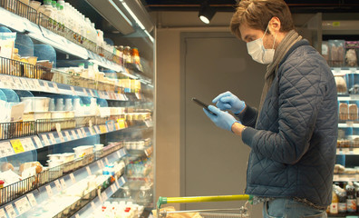 Handsome man with smartphone in the store