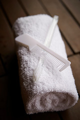 Fototapeta na wymiar White bath towels with grooming items 