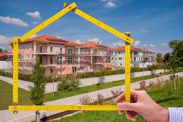newly built house with a yardstick