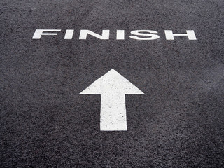 white finish and white arrow on black asphalt