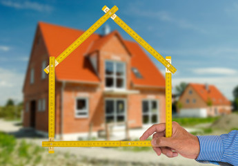 newly built house with a yardstick