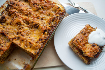 Juicy meat lasagna, cassic dish of Italian cuisine with dough, meat and sauce with creamy soft mozzarella cheese.