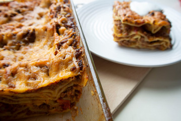 Juicy meat lasagna, cassic dish of Italian cuisine with dough, meat and sauce with creamy soft mozzarella cheese.
