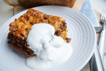 Juicy meat lasagna, cassic dish of Italian cuisine with dough, meat and sauce with creamy soft mozzarella cheese.