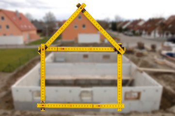 newly built house with a yardstick