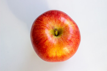 Three apples, one green and two red-yellow on a light background.