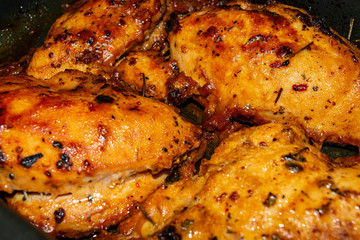 Chicken breast baked with spices in the oven. Close up.