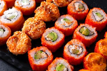 many sushi , set of Japanese rolls  California with caviar,   Philadelphia with salmon, baked with cheese and eel,