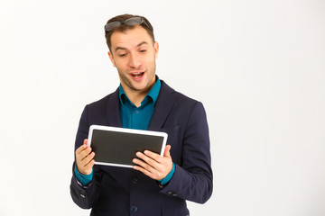 A view of a shocked young businessman isolated on white background
