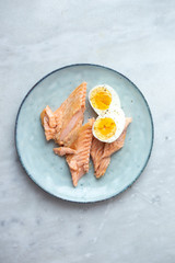 Salmon and egg on rustic plate