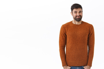 Portrait of awkward and uncomfortable caucasian bearded man, smirk and grimacing, cringe unwilling...