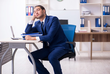 Young male businessman working in the office