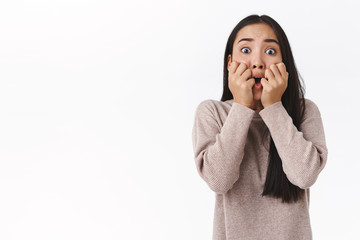 Scared trembling and speechless attractive young asian millennial girl, shivering and screaming,...